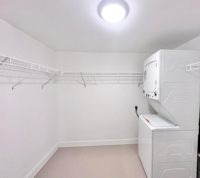 laundry area featuring stacked washer and clothes dryer