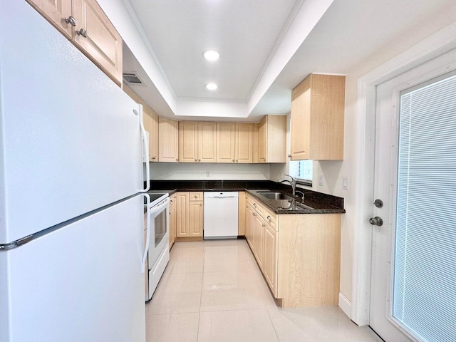 kitchen with sink, a tray ceiling, white appliances, light tile patterned flooring, and light brown cabinetry