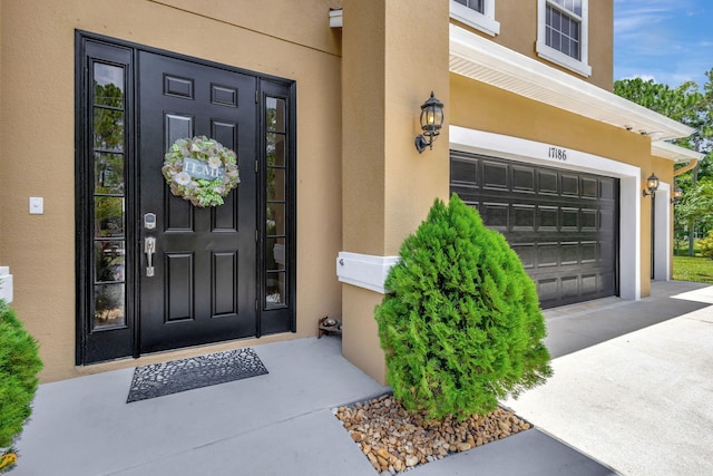 view of exterior entry featuring a garage