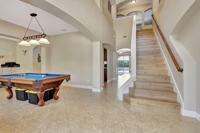 recreation room with billiards and a towering ceiling