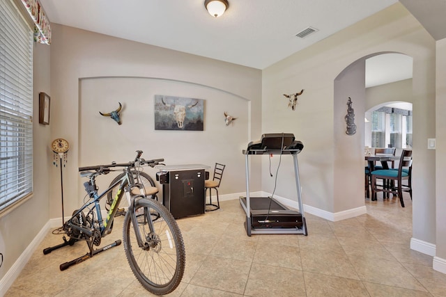 workout area with light tile patterned flooring