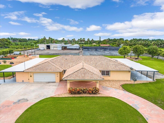 view of front of property featuring a garage and a front lawn