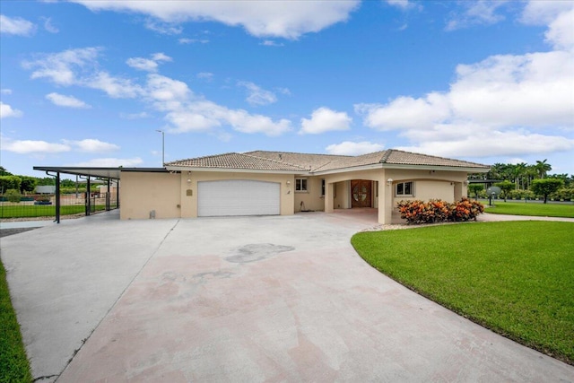 view of front of property with a carport, a garage, and a front yard