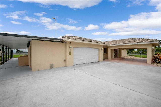 view of side of property featuring a garage and a carport