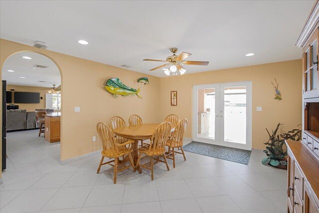 dining area with french doors, light tile patterned floors, and ceiling fan