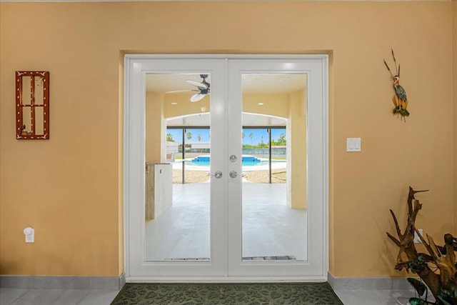 entryway with french doors, ceiling fan, and tile patterned floors