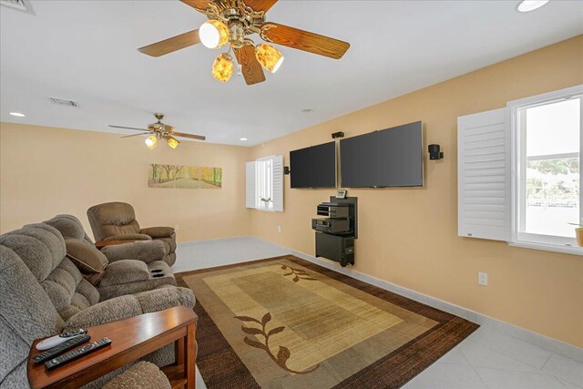 living room with light tile patterned floors and ceiling fan