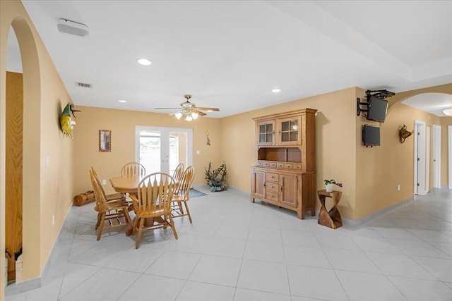 dining room featuring ceiling fan, light tile patterned floors, and french doors