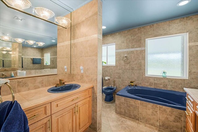 bathroom featuring a bidet, tile walls, tile patterned floors, and vanity