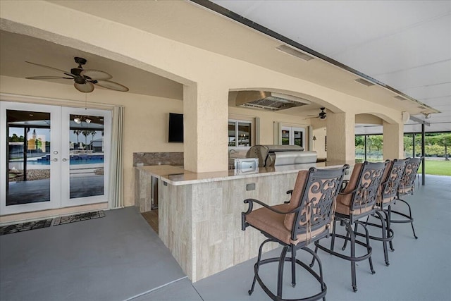 view of patio featuring exterior bar, french doors, and ceiling fan