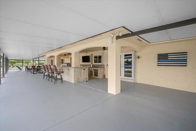 view of patio / terrace with a bar and ceiling fan