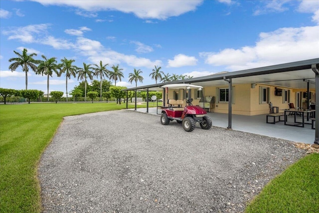 view of car parking with a lawn and a carport