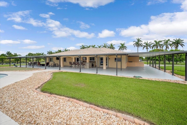 rear view of house with a yard and a patio area