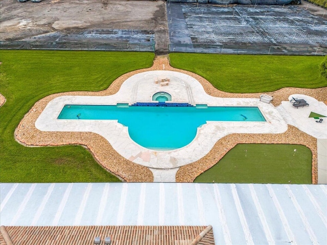 view of pool with a yard and an in ground hot tub