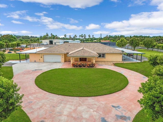 view of front of house with a garage, a carport, and a front lawn