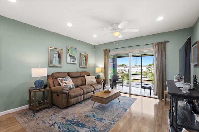 living room featuring ceiling fan and wood-type flooring