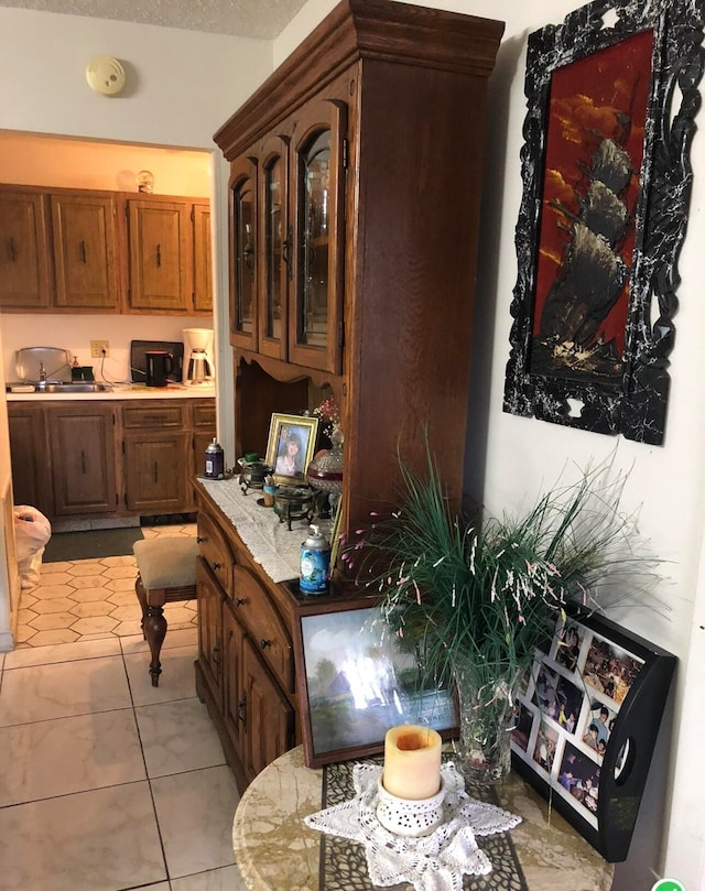 kitchen featuring light tile patterned flooring and built in desk