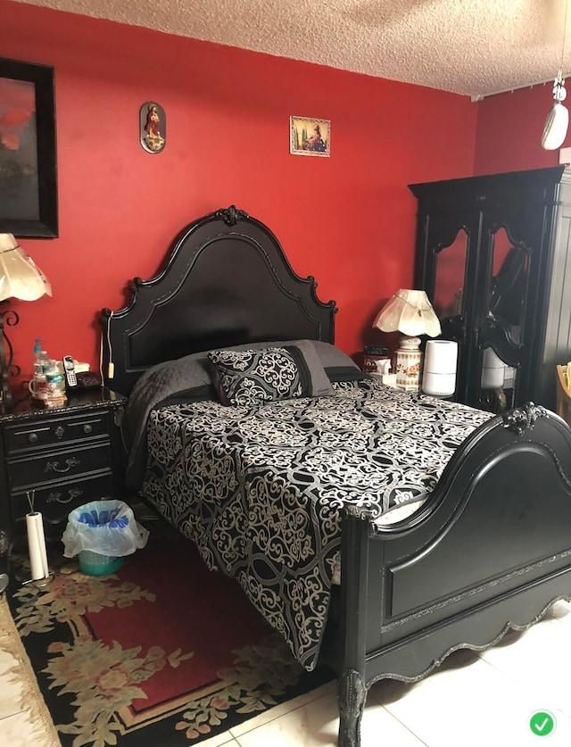 tiled bedroom featuring a textured ceiling