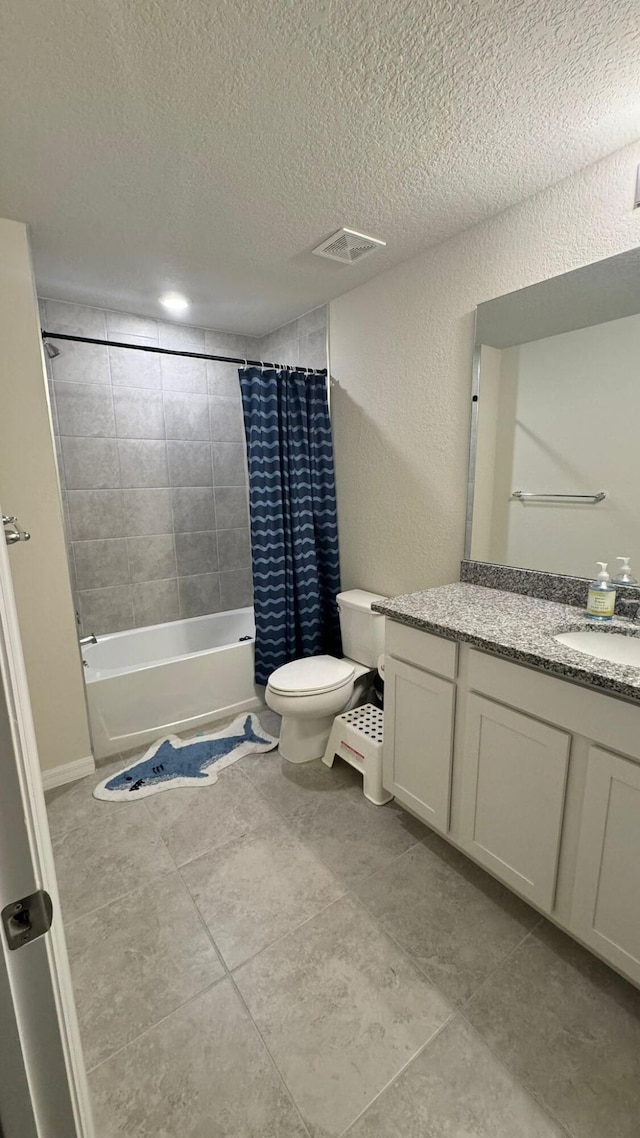 full bathroom featuring toilet, tile patterned flooring, vanity, a textured ceiling, and shower / bathtub combination with curtain