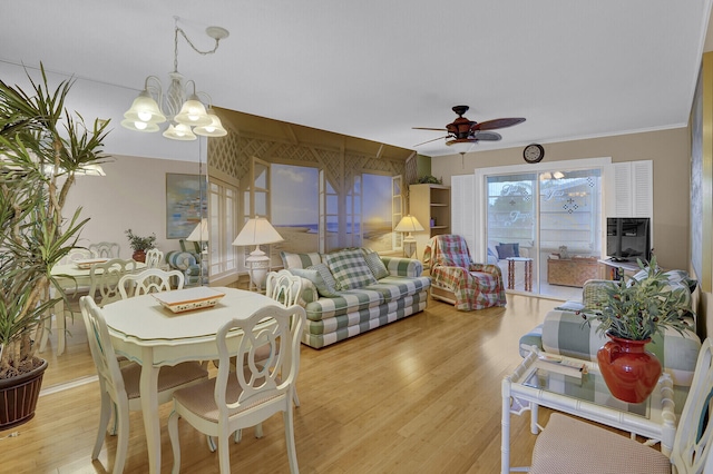 dining room featuring ceiling fan with notable chandelier, ornamental molding, and light hardwood / wood-style flooring