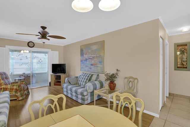 living room featuring light hardwood / wood-style flooring, ceiling fan, and ornamental molding