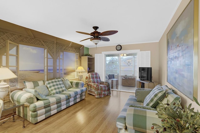 living room with ceiling fan, light wood-type flooring, and crown molding