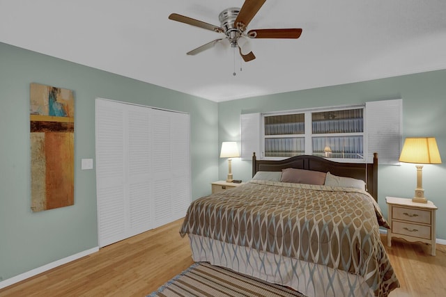 bedroom with ceiling fan, light wood-type flooring, and a closet