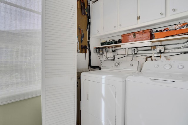 laundry room with washer and clothes dryer and cabinets