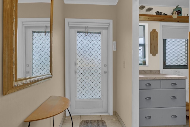 entryway featuring a wealth of natural light, crown molding, and light tile patterned flooring