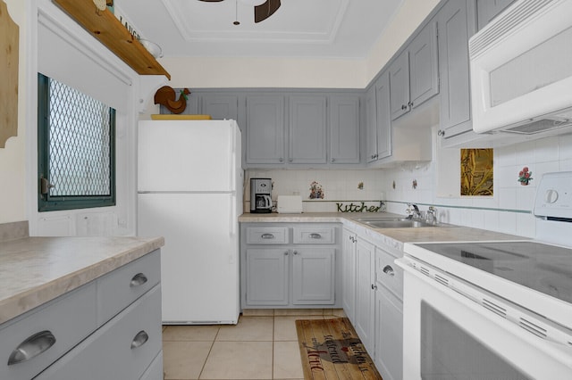 kitchen with sink, tasteful backsplash, white appliances, gray cabinets, and light tile patterned floors