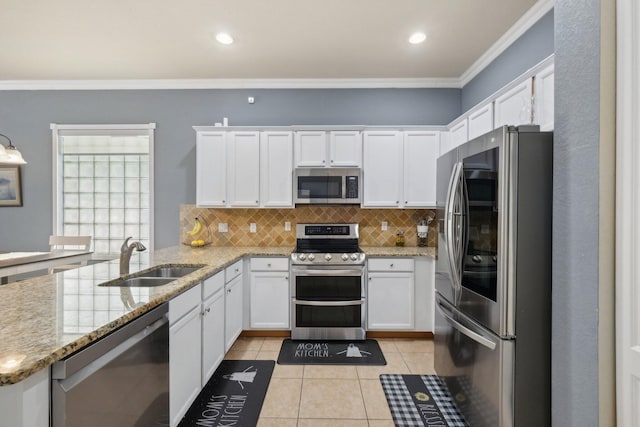 kitchen with stainless steel appliances, sink, white cabinetry, light tile patterned floors, and light stone countertops