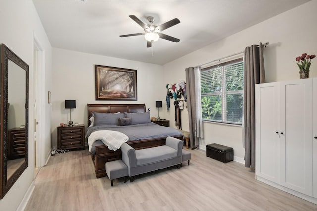 bedroom with ceiling fan, light hardwood / wood-style flooring, and a closet