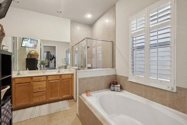 bathroom with shower with separate bathtub, tile patterned floors, and vanity