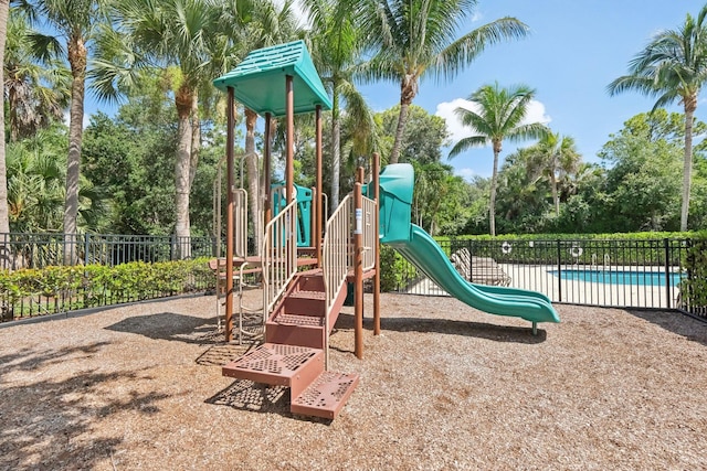 view of jungle gym featuring a community pool