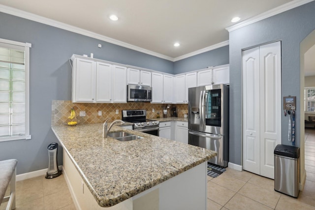 kitchen with white cabinets, stainless steel appliances, and kitchen peninsula