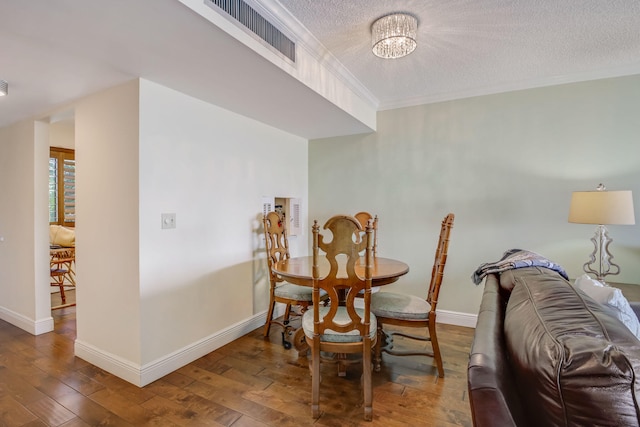 dining space featuring wood-type flooring, a chandelier, and a textured ceiling