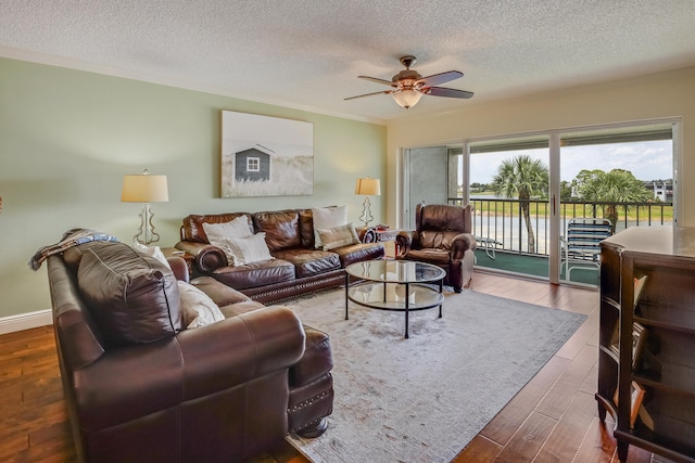 living room with a textured ceiling, ceiling fan, and hardwood / wood-style floors