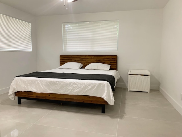 bedroom with light tile patterned floors