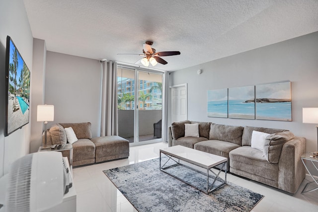 tiled living room featuring a textured ceiling and ceiling fan