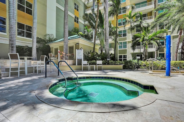 view of swimming pool featuring a community hot tub