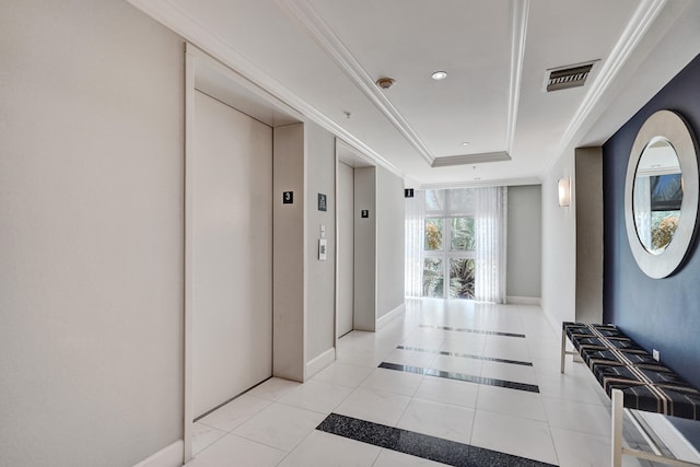 corridor with elevator, expansive windows, a raised ceiling, and light tile patterned floors