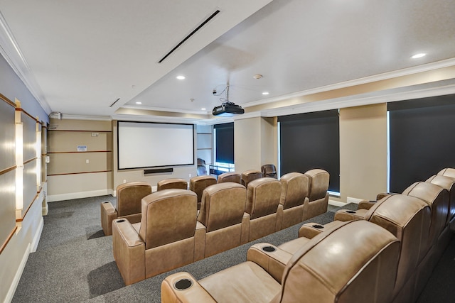 carpeted home theater with a tray ceiling and ornamental molding