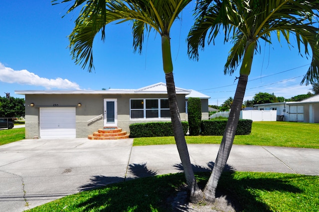 view of front of property with a garage and a front yard