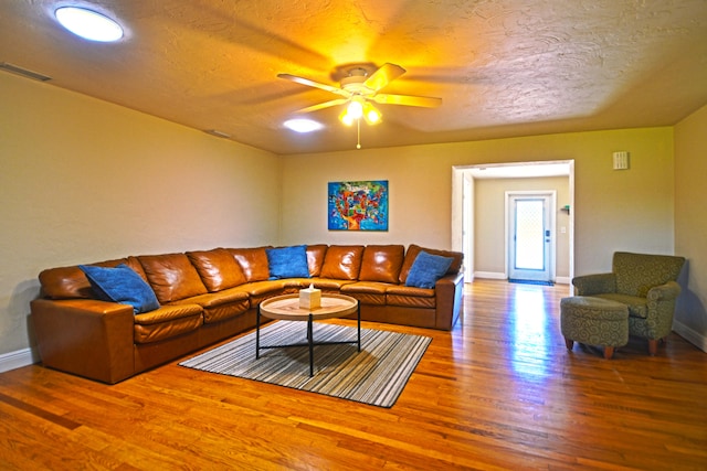 living room with ceiling fan and hardwood / wood-style floors