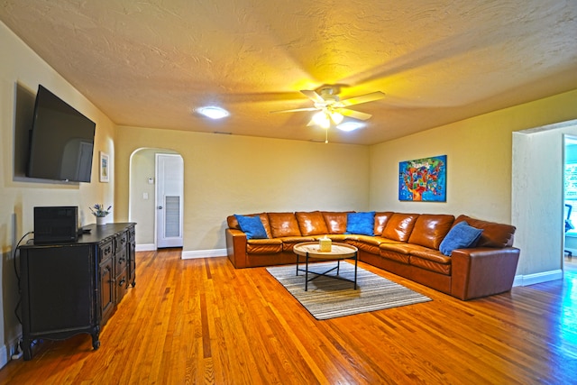 living room featuring ceiling fan and hardwood / wood-style floors