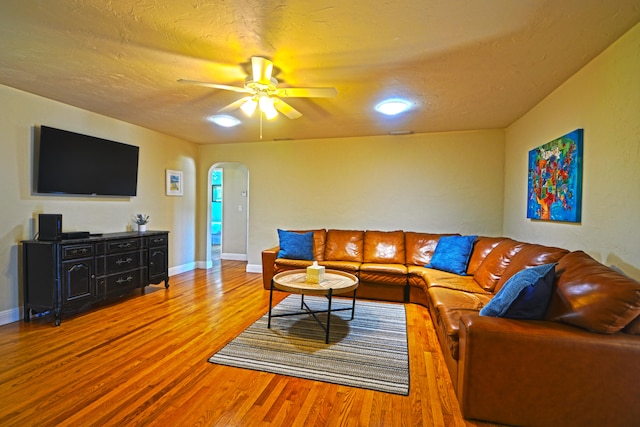 living room with wood-type flooring and ceiling fan