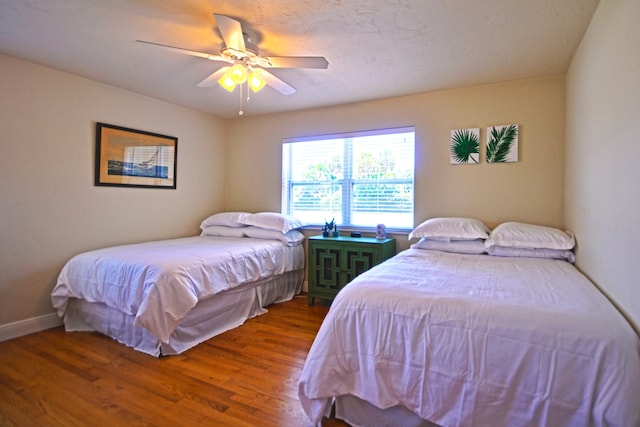 bedroom featuring dark hardwood / wood-style flooring and ceiling fan