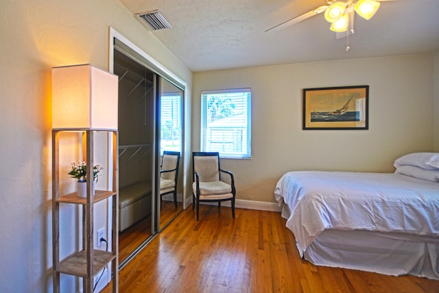 bedroom featuring ceiling fan, a closet, and wood-type flooring