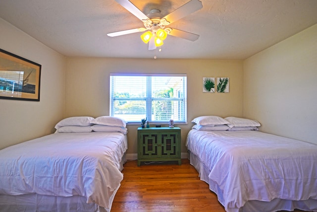 bedroom with wood-type flooring and ceiling fan