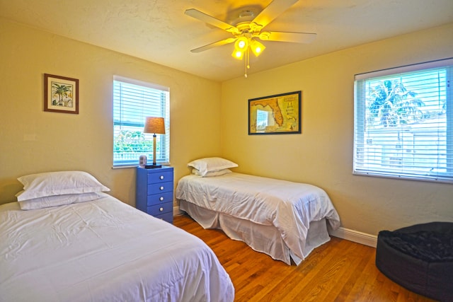 bedroom featuring hardwood / wood-style floors and ceiling fan